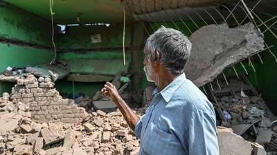 A local resident points towards his house damaged by overnight Pakistani artillery shelling in Kotmaira village near the Line of Control (LoC) in Jammu region on May 11, 2025. (AFP) A local resident points towards his house damaged by overnight Pakistani artillery shelling in Kotmaira village near the Line of Control (LoC) in Jammu region on May 11, 2025. (AFP)