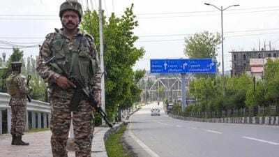 Security personnel stand guard on a road towards the airport, in light of the ongoing military conflict between India and Pakistan, in Srinagar, Jammu and Kashmir. (PTI Photo/S Irfan) (PTI05_10_2025_000173B) (PTI) Security personnel stand guard on a road towards the airport, in light of the ongoing military conflict between India and Pakistan, in Srinagar, Jammu and Kashmir. (PTI Photo/S Irfan) (PTI05_10_2025_000173B) (PTI)