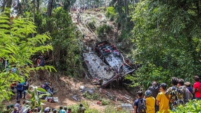 People gather at the site of a bus accident in the central hilly region of Kotmale. (AFP)
