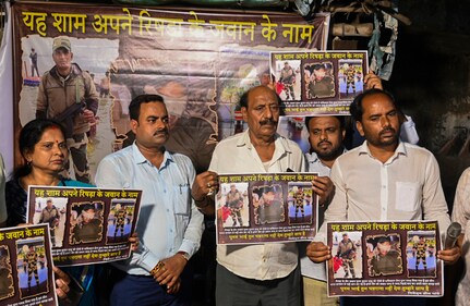 Neighbours hold posters demanding the safe return of BSF constable Purnam Kumar Shaw who is in Pakistan custody, at Rishra in Hooghly district, West Bengal, Saturday, April 26, 2025. (PTI) Neighbours hold posters demanding the safe return of BSF constable Purnam Kumar Shaw who is in Pakistan custody, at Rishra in Hooghly district, West Bengal, Saturday, April 26, 2025. (PTI)