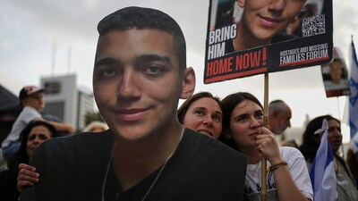 People watch a live broadcast of Israeli-American soldier Edan Alexander as he is released from Hamas captivity in Gaza, at a plaza known as the hostages square in Tel Aviv, Monday, May 12, 2025. (AP) People watch a live broadcast of Israeli-American soldier Edan Alexander as he is released from Hamas captivity in Gaza, at a plaza known as the hostages square in Tel Aviv, Monday, May 12, 2025. (AP)