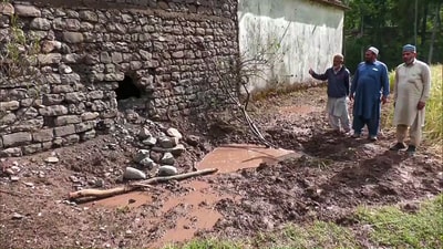 People stand near the debris of a projectile retrieved, in Poonch on Monday. (ANI) People stand near the debris of a projectile retrieved, in Poonch on Monday. (ANI)