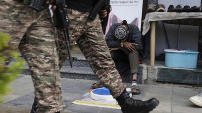 Soldiers patrol as a street vendor takes a nap after India and Pakistan reported no incidents of firing overnight in Srinagar on Monday (AP) Soldiers patrol as a street vendor takes a nap after India and Pakistan reported no incidents of firing overnight in Srinagar on Monday (AP)
