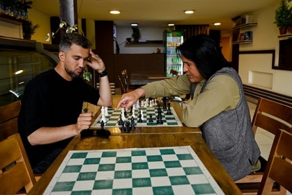 Azizullah Gulzada (R), owner of the Cupcake Coffee Shop plays chess with a friend at his cafe in Kabul On May 11, 2025. Taliban authorities have barred chess across Afghanistan until further notice over concerns it is a source of gambling, which is illegal under the government's morality law, a sports official said on May 11. (Photo by Wakil KOHSAR / AFP) (AFP) Azizullah Gulzada (R), owner of the Cupcake Coffee Shop plays chess with a friend at his cafe in Kabul On May 11, 2025. Taliban authorities have barred chess across Afghanistan until further notice over concerns it is a source of gambling, which is illegal under the government's morality law, a sports official said on May 11. (Photo by Wakil KOHSAR / AFP) (AFP)
