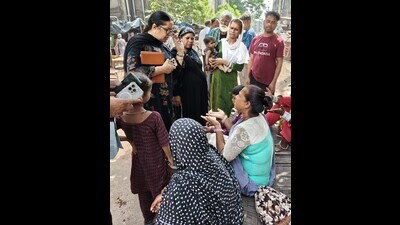 An education official interacts with residents to make them admit their wards in government schools. (HT Photo) An education official interacts with residents to make them admit their wards in government schools. (HT Photo)