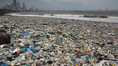 Mumbai, India - June 22, 2021: BMC workers clear garbage using JCB earthmover during low tide on Mahim beach, that flows into the sea through the Mithi river, in Mumbai, India, on Thursday, June 22, 2021. (Photo by Satish Bate/Hindustan Times) (Satish Bate/HT PHOTO) Mumbai, India - June 22, 2021: BMC workers clear garbage using JCB earthmover during low tide on Mahim beach, that flows into the sea through the Mithi river, in Mumbai, India, on Thursday, June 22, 2021. (Photo by Satish Bate/Hindustan Times) (Satish Bate/HT PHOTO)