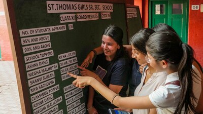 Class 12 students check their scores after CBSE declared the board exam results, at St. Thomas' Girls Senior Secondary School in New Delhi. (PTI) Class 12 students check their scores after CBSE declared the board exam results, at St. Thomas' Girls Senior Secondary School in New Delhi. (PTI)