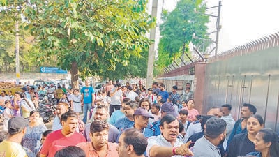 Parents outside the school during the protest. (HT Photo) Parents outside the school during the protest. (HT Photo)