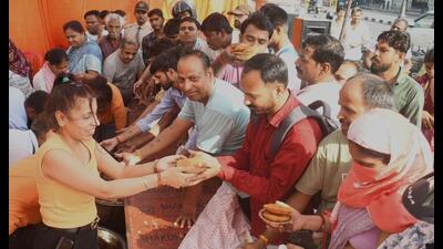 People taking ‘prasad’ at a bhandara on the first Bada Mangal in Lucknow. (Mushtaq Ali/HT Photo) People taking ‘prasad’ at a bhandara on the first Bada Mangal in Lucknow. (Mushtaq Ali/HT Photo)