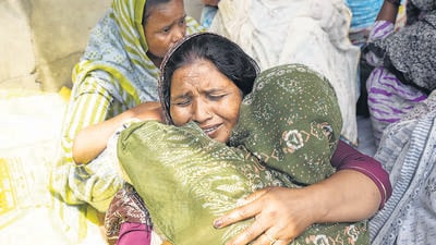 Relatives of one of the victims in Mardi Kalan village. (PTI) Relatives of one of the victims in Mardi Kalan village. (PTI)
