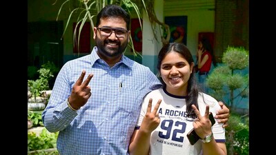 Yamuna Goyal, who got 99.4% in commerce stream, shares her happiness with her relative on Tuesday. (Gurpreet Singh/HT) Yamuna Goyal, who got 99.4% in commerce stream, shares her happiness with her relative on Tuesday. (Gurpreet Singh/HT)
