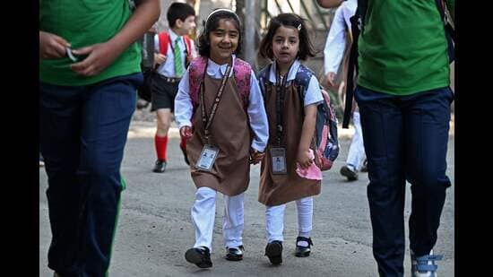 Students walk to attend classes in Srinagar on Tuesday. (AFP)