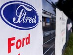 The word "Strike" is displayed in the typography of Ford logo on a banner, as workers rally during a strike by IG Metall union at a Ford plant in Cologne, Germany, May 14, 2025. 