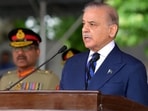 Pakistan's Prime Minister Shehbaz Sharif (R) speaks while attending a passing out parade at the Pakistan Military Academy (PMA) Kakul, in Abbottabad.