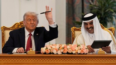 President Donald Trump holds up a pen given by Qatar's Emir Sheikh Tamim bin Hamad Al Thani in Doha, Qatar. (AP) President Donald Trump holds up a pen given by Qatar's Emir Sheikh Tamim bin Hamad Al Thani in Doha, Qatar. (AP)