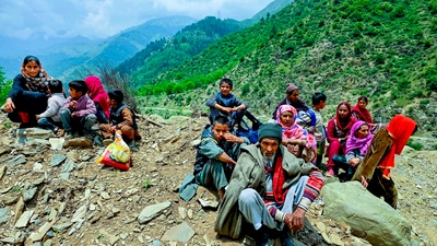 People wait after authorities in J&K asked residents of border villages not to rush back to homes until the areas are sanitized and cleared of any unexplored shells in Baramulla. (PTI) People wait after authorities in J&K asked residents of border villages not to rush back to homes until the areas are sanitized and cleared of any unexplored shells in Baramulla. (PTI)