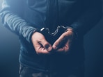 Arrested computer hacker and cyber criminal with handcuffs, close up of hands. (iStockphoto) Arrested computer hacker and cyber criminal with handcuffs, close up of hands. (iStockphoto)