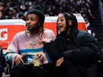 Rapper DDG, left, and singer Halle Bailey watch during the second half of an NBA basketball game between the Los Angeles Clippers and the Golden State Warriors, Thursday, Dec. 14, 2023, in Los Angeles. (AP Photo/Ryan Sun)