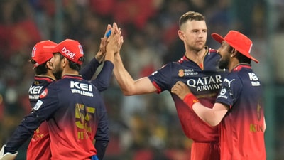 Royal Challengers Bengaluru's Josh Hazlewood, second left, celebrates with RCB teammates (AP) Royal Challengers Bengaluru's Josh Hazlewood, second left, celebrates with RCB teammates (AP)