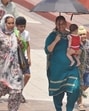 A woman shields her child from the scorching heat under an umbrella in Amritsar on Thursday. (Sameer Sehgal/HT)