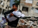 A Palestinian man carries the body of a child killed in Israeli strikes, in Jabalia, in the northern Gaza Strip May 16, 2025. A Palestinian man carries the body of a child killed in Israeli strikes, in Jabalia, in the northern Gaza Strip May 16, 2025.