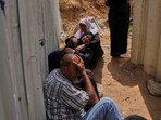 Palestinians mourn their relatives who were killed in Israeli airstrikes on a medical center in Jabalia, northern Gaza Strip, on Thursday.