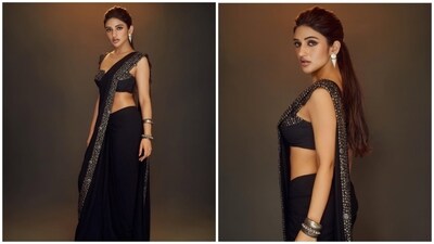 Sreeleela also sported a stunning black georgette saree featuring intricate embellishments along the edges, and paired it with a bold balconette blouse. Her outfit is from the label Qbik. With her hair tied into a sleek ponytail, she looked glamorous. Sreeleela also sported a stunning black georgette saree featuring intricate embellishments along the edges, and paired it with a bold balconette blouse. Her outfit is from the label Qbik. With her hair tied into a sleek ponytail, she looked glamorous.