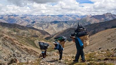 Porters cross the Shey La Pass in Dolpo region of the Himalaya in Nepal. (Getty Images) Porters cross the Shey La Pass in Dolpo region of the Himalaya in Nepal. (Getty Images)