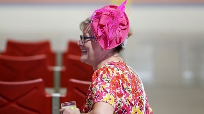 A woman beams with joy on Black-Eyed Susan Day, sporting a chic pink hat with a delicate net, adding a touch of elegance to the festivities before the 150th Preakness Stakes at Pimlico Race Course in Baltimore. Emilee Chinn/Getty Images/AFP (Photo by Emilee Chinn / GETTY IMAGES NORTH AMERICA / Getty Images via AFP) (Getty Images via AFP) A woman beams with joy on Black-Eyed Susan Day, sporting a chic pink hat with a delicate net, adding a touch of elegance to the festivities before the 150th Preakness Stakes at Pimlico Race Course in Baltimore. Emilee Chinn/Getty Images/AFP (Photo by Emilee Chinn / GETTY IMAGES NORTH AMERICA / Getty Images via AFP) (Getty Images via AFP)