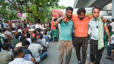 Teachers and non-teaching staff stage a sit-in protest on Friday to demand that non-tainted teachers be allowed to continue in service without any conditions. (ANI)