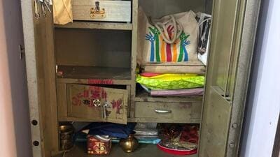The cash was hidden in a metal cupboard that was concealed behind a wooden door The cash was hidden in a metal cupboard that was concealed behind a wooden door
