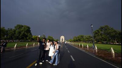 Visitors enjoy the sudden rain on Kartavya Path, in New Delhi, on Friday. (Sanjeev Verma/HT Photo) Visitors enjoy the sudden rain on Kartavya Path, in New Delhi, on Friday. (Sanjeev Verma/HT Photo)