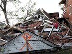 A house lies completely collapsed under a mountain of bricks, after a tornado struck in St. Louis, Missouri.