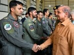 Pakistan's Prime Minister Shehbaz Sharif greets pilots during a visit to Pakistan Air Force's base at Kamra. Pakistan's Prime Minister Shehbaz Sharif greets pilots during a visit to Pakistan Air Force's base at Kamra.