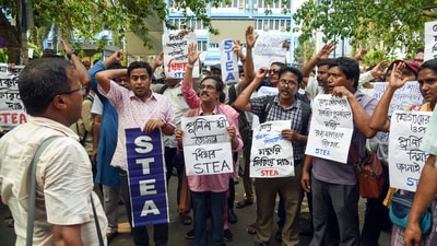Teachers and non-teaching staff stage a sit-in protest against police lathi-charge on protesters on May 15 in front of Bikash Bhawan during a protest against the Supreme Court's order to cancel appointments of over 25,000 staff. (ANI) Teachers and non-teaching staff stage a sit-in protest against police lathi-charge on protesters on May 15 in front of Bikash Bhawan during a protest against the Supreme Court's order to cancel appointments of over 25,000 staff. (ANI)