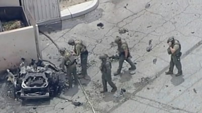 Law enforcement investigate a vehicle after an explosion on Saturday, May 17, 2025 in Palm Springs, Calif. (AP)