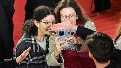 Guests try to take a selfie as they arrive for the screening of the film "Fung Lam Fo Saan" (Sons of the Neon Night) at the 78th edition of the Cannes Film Festival in Cannes, southern France, on May 16, 2025. (Photo by Antonin THUILLIER / AFP) (AFP) Guests try to take a selfie as they arrive for the screening of the film "Fung Lam Fo Saan" (Sons of the Neon Night) at the 78th edition of the Cannes Film Festival in Cannes, southern France, on May 16, 2025. (Photo by Antonin THUILLIER / AFP) (AFP)