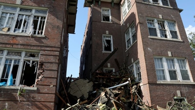 Debris fills the alley between two heavily damaged apartment buildings after tornadoes ripped through shattering windows and tearing through brick walls in St. Louis, Missouri. (REUTERS)