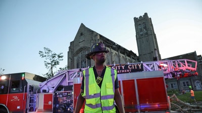 A firefighter from the University City Fire Department stands in front of a damaged church after a tornado swept through the area in St. Louis, Missouri. (REUTERS)