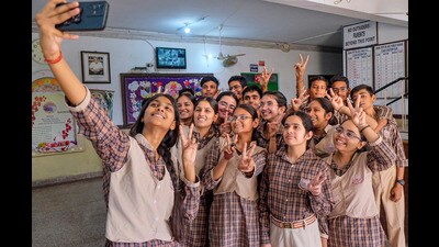 Students take a selfie as they celebrate after the declaration of Haryana Board of School Education Class 10 results in Gurugram on Saturday. (PTI)