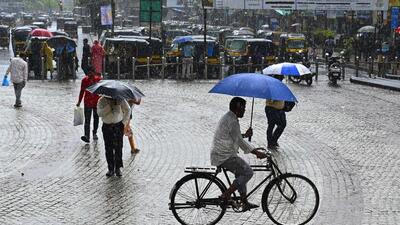 Thane, India - May - People going through the rain at Mira Road in suburb north of Mumbai, India, on, Saturday, May -17, 2025. ( HT Photo ) Thane, India - May - People going through the rain at Mira Road in suburb north of Mumbai, India, on, Saturday, May -17, 2025. ( HT Photo )