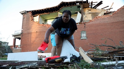 A young woman gathers shoes from the debris of her tornado-damaged home in St. Louis, Missouri,U.S. May 16, 2025. REUTERS/Lawrence Bryant (REUTERS)