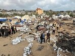 Palestinians inspect the debris at the site of Israeli strikes as a new IDF offensive intensifies. Palestinians inspect the debris at the site of Israeli strikes as a new IDF offensive intensifies.