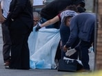 Investigators look at possible evidence near the American Reproductive Centers fertility clinic following a bomb blast on May 17, 2025 in Palm Springs, California. 