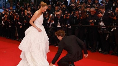 Robert Pattinson, right, adjusts Jennifer Lawrence's dress upon arrival at the premiere of the film 'Die, My Love' at the 78th international film festival, Cannes, southern France, Saturday, May 17, 2025. AP/PTI(AP05_18_2025_000037B) (AP) Robert Pattinson, right, adjusts Jennifer Lawrence's dress upon arrival at the premiere of the film 'Die, My Love' at the 78th international film festival, Cannes, southern France, Saturday, May 17, 2025. AP/PTI(AP05_18_2025_000037B) (AP)