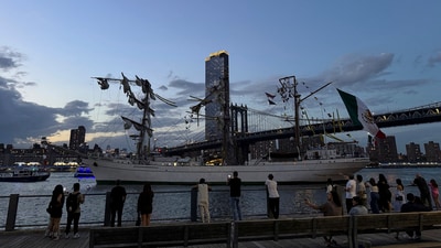 Pedestrians walking along Brooklyn Bridge Park look on as a masted Mexican Navy training ship sits stranded near the Manhattan Bridge after colliding with the Brooklyn Bridge, Saturday, May 17, 2025, in New York. (Nick Corso via AP) (AP)
