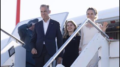 Prime Minister Mark Carney disembarks a government plane with daughter Cleo and wife Diana Fox Carney, on Saturday. (AP) Prime Minister Mark Carney disembarks a government plane with daughter Cleo and wife Diana Fox Carney, on Saturday. (AP)