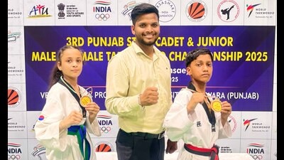 Taekwondo champions Chetan Gupta and Manmeet Kaur with their coach in Ludhiana. (HT Photo)