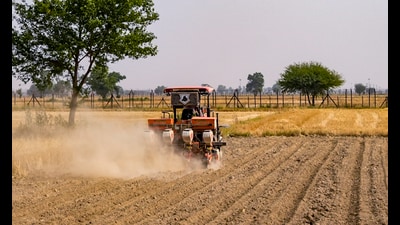 A farmer works on a field close to the India-Pakistan border fencing in Amritsar. (PTI File) A farmer works on a field close to the India-Pakistan border fencing in Amritsar. (PTI File)