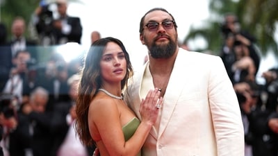 Adria Arjona, left, and Jason Momoa pose for photographers upon arrival at the premiere of the film 'Highest 2 Lowest' at the 78th international film festival, Cannes, southern France, Monday, May 19, 2025.AP/PTI(AP05_19_2025_000506A) (AP) Adria Arjona, left, and Jason Momoa pose for photographers upon arrival at the premiere of the film 'Highest 2 Lowest' at the 78th international film festival, Cannes, southern France, Monday, May 19, 2025.AP/PTI(AP05_19_2025_000506A) (AP)
